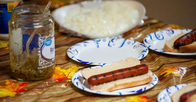 Hot dogs, chips, drinks, popcorn, and candy waiting to be eaten at the block party.