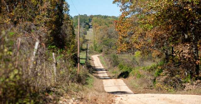 A dirt road winding through the country.
