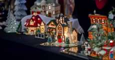 Little Christmas houses lined up on a table.
