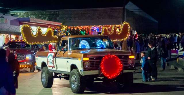 A pickup truck decorated as a reindeer.