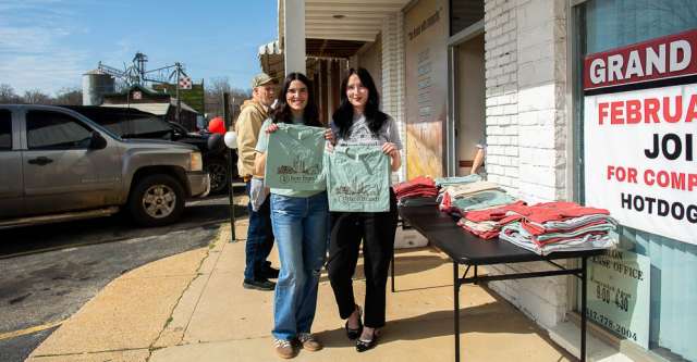 Shelli Gatewood and Brittany Madden pose for a picture with t-shirts.