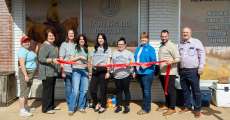 Members from Iron Brand Realty, USA Mortgage, Alton Bank, and AltonMo.com cutting the ribbon at the grand opening.