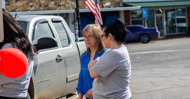 Individuals talking with each other at Iron Brand Realty's grand opening.