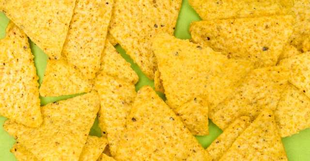 Tortilla chips laying on a plate.