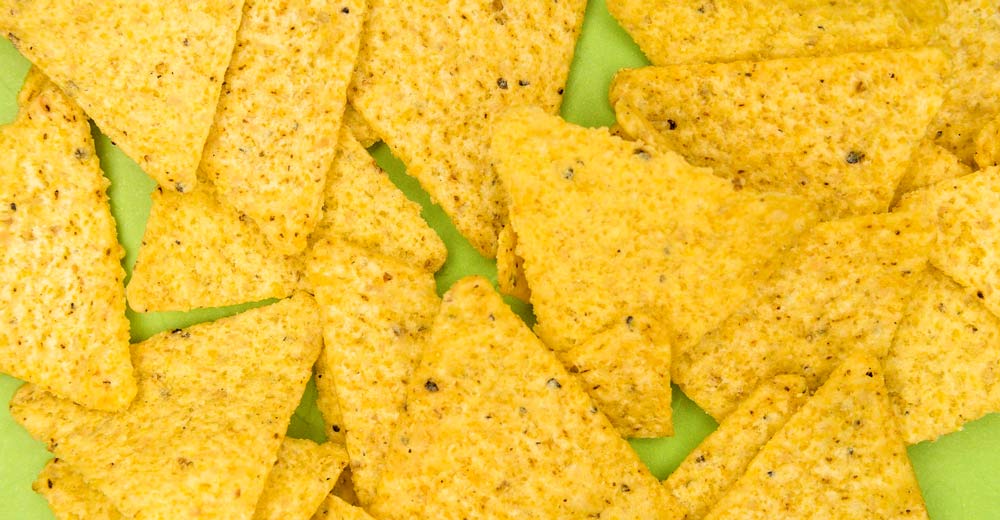 Tortilla chips laying on a plate.