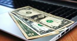 Money laying on a laptop.