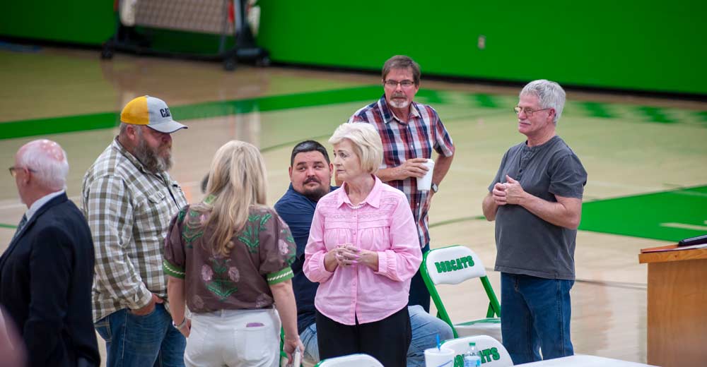 Individuals talking at the Thayer town hall meeting on April 2, 2026.