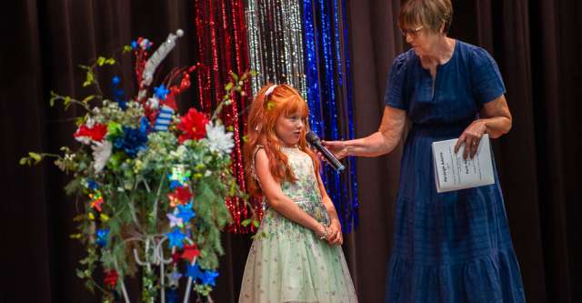 A girl in the younger age category tells the audience about herself.