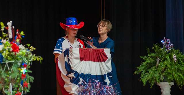 A young lady in her patriotic apparel gives her speech.