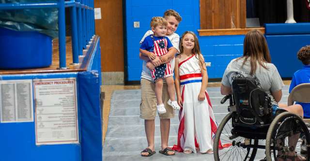 Two brothers pose with their sister after the pageant.