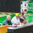 Individuals sitting at a table during the town hall.