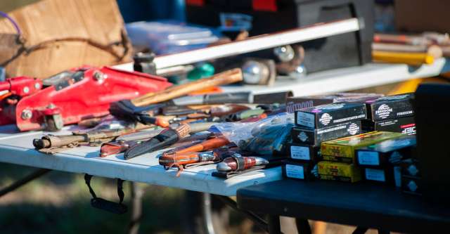 Ammo, knives, and other items for sale at a swap meet.