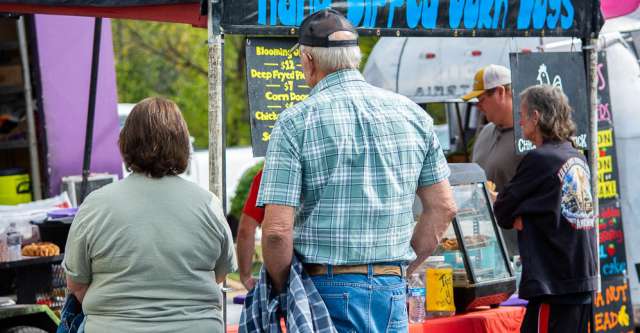 A couple waits in line to get some food.