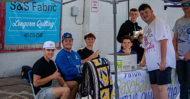 Players on the Alton Baseball Team pose for a picture at the Walnut Festival.