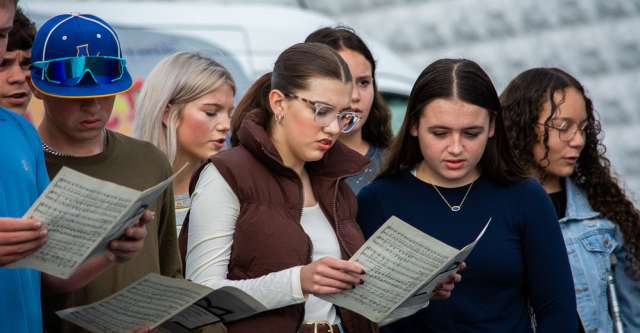 The senior high choirs singing.