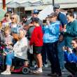 Families and community members listen to the choirs sing.